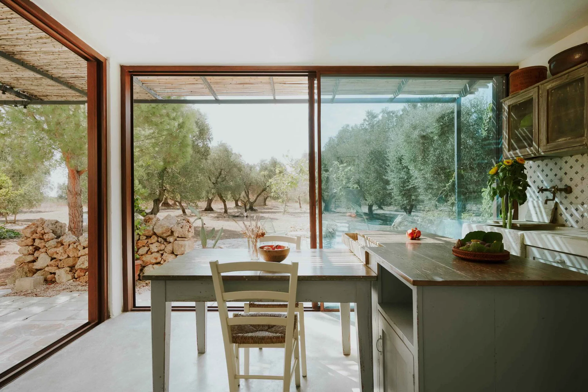 Kitchen and dining table opening onto the olive grove