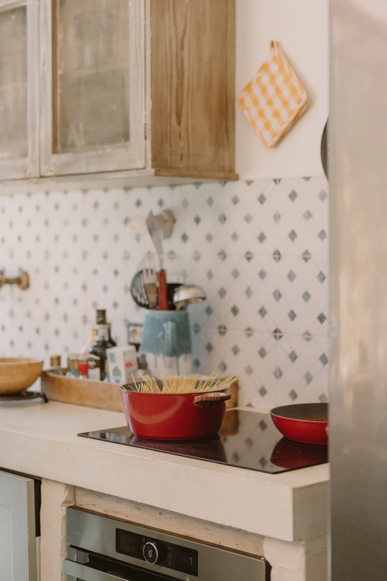Lunch on the stove, against the patterned tiles