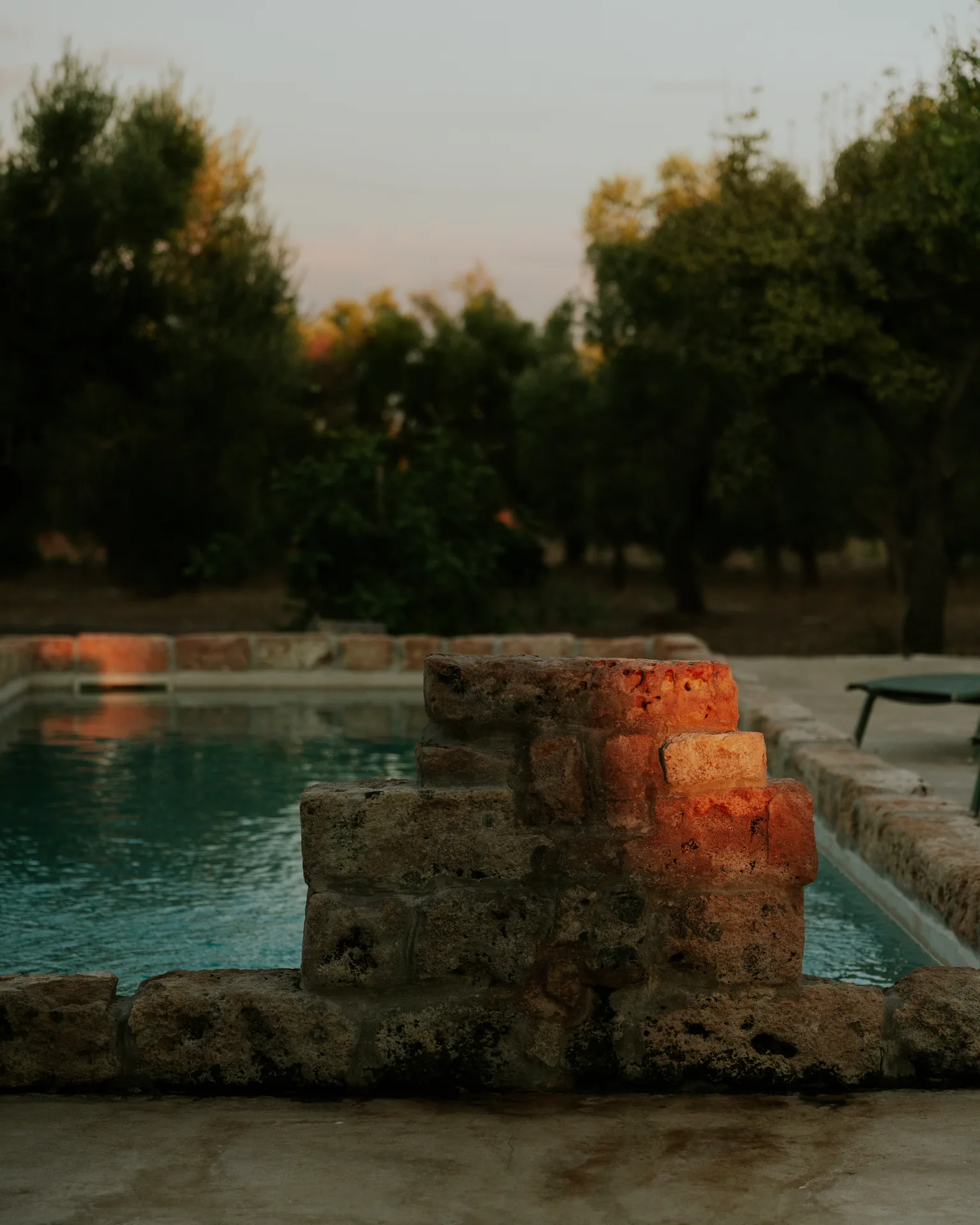 The pool at dusk, the last light on the stone
