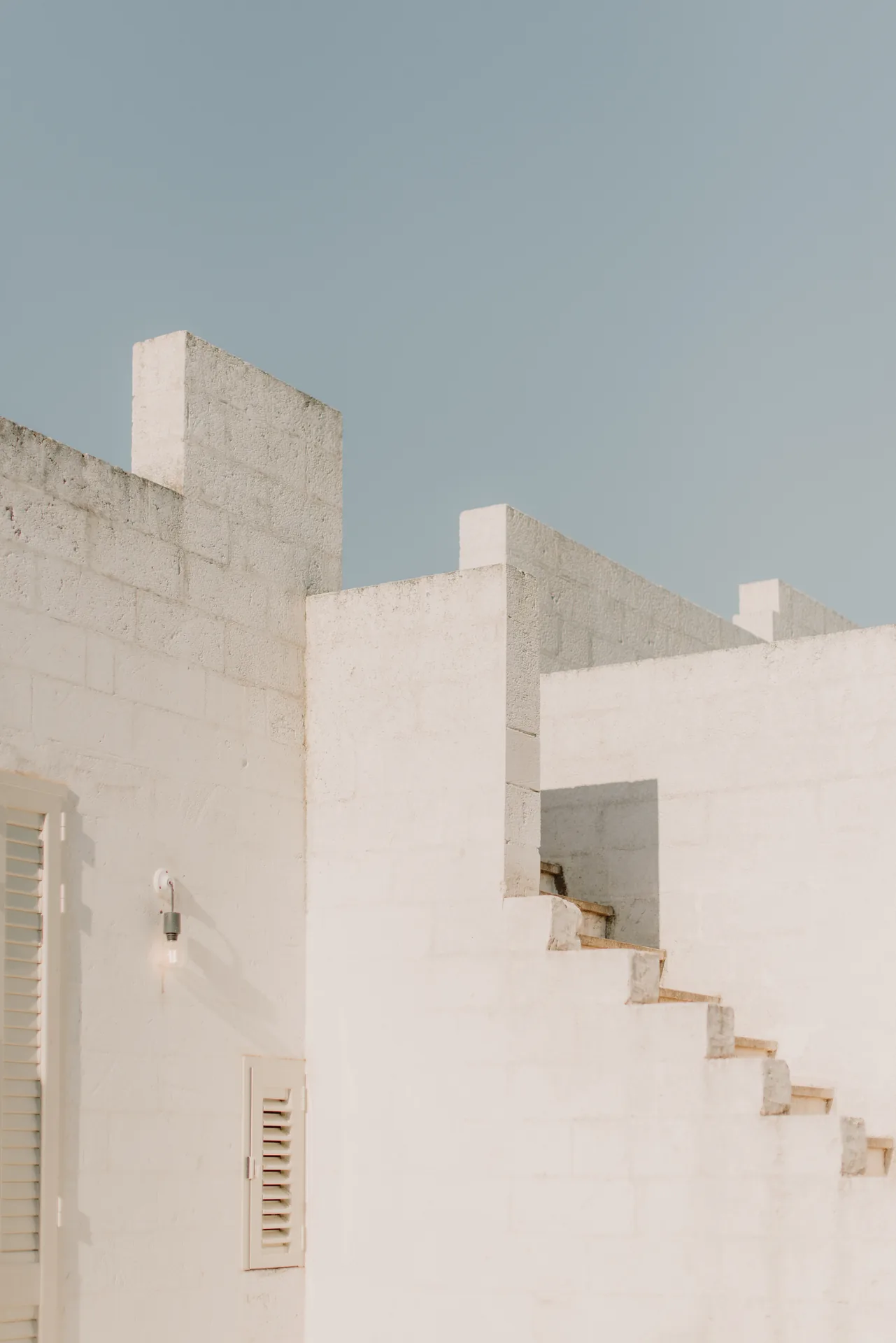 White stairs climbing to the roof terrace